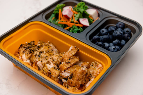 Meal Clickit container loaded with chicken, salad, and blueberries